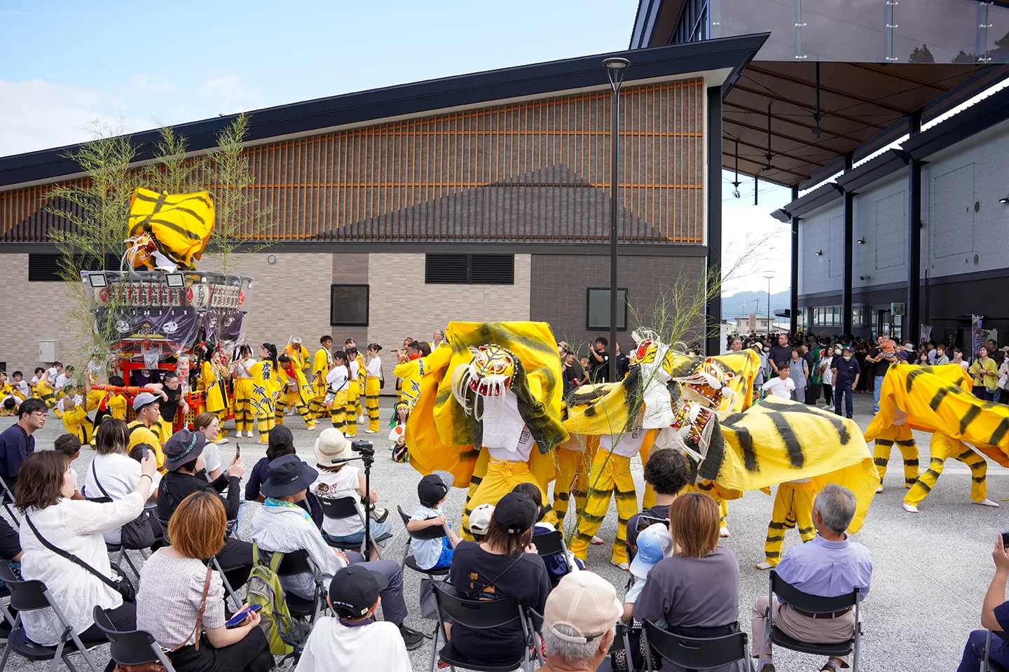 Toramai tiger dance troupe performing before spectators in a plaza at Yamada Matsuri