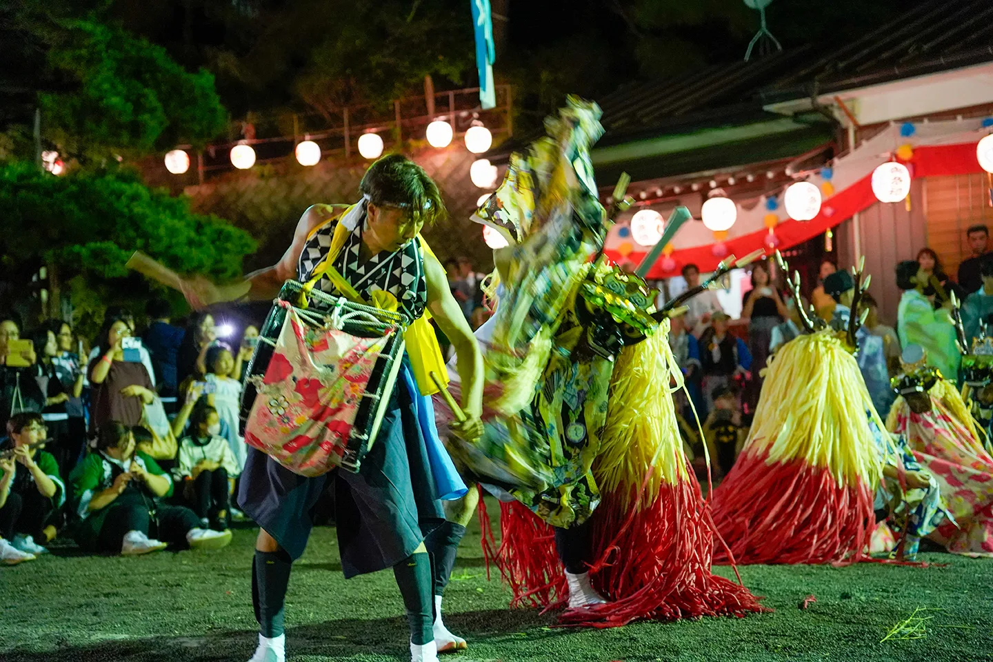 Drummer and deer-headed dancers performing at night during Yamada Matsuri